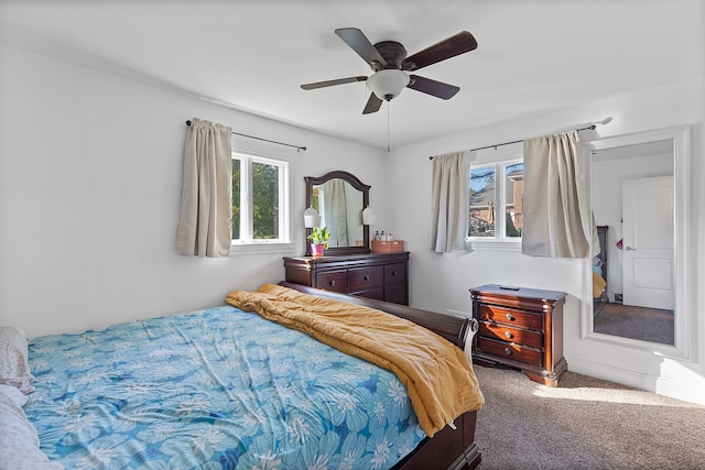 bedroom featuring multiple windows, carpet floors, and ceiling fan