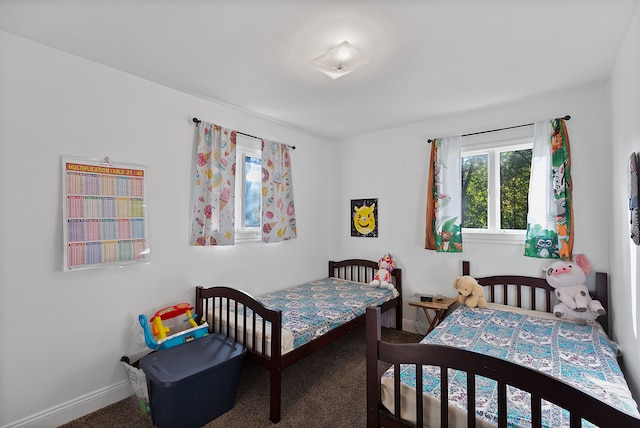 bedroom with dark colored carpet