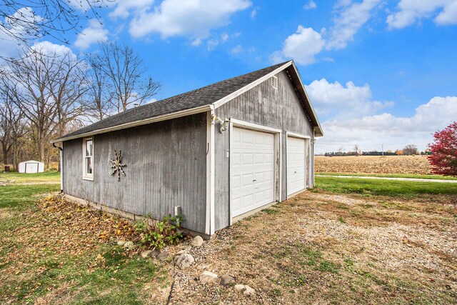 detached garage with a rural view