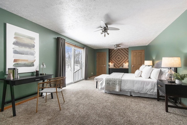 carpeted bedroom with access to outside, ceiling fan, and a textured ceiling