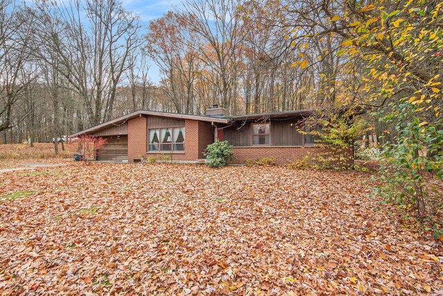 288 E 88th St, Newaygo, MI 49337 - view of front of home with brick siding and a chimney