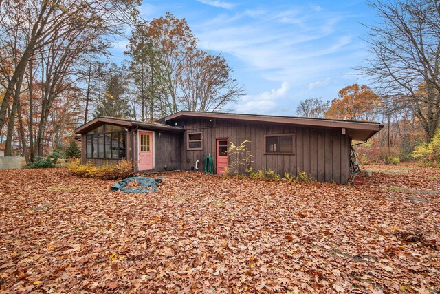 288 E 88th St, Newaygo, MI 49337 - back of house with a sunroom and board and batten siding