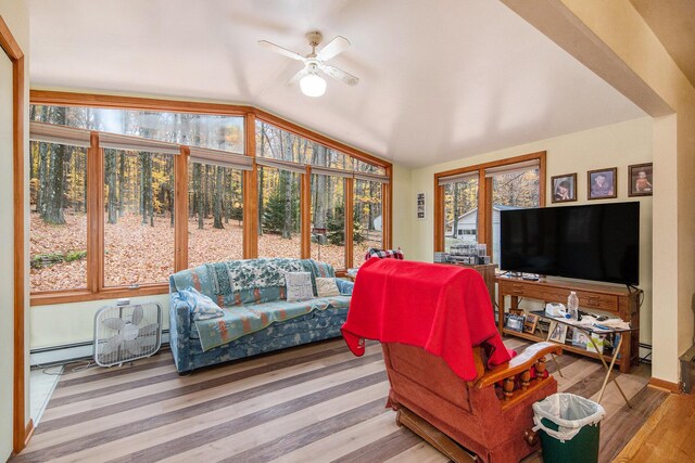 288 E 88th St, Newaygo, MI 49337 - living room with vaulted ceiling, a ceiling fan, wood finished floors, and baseboard heating