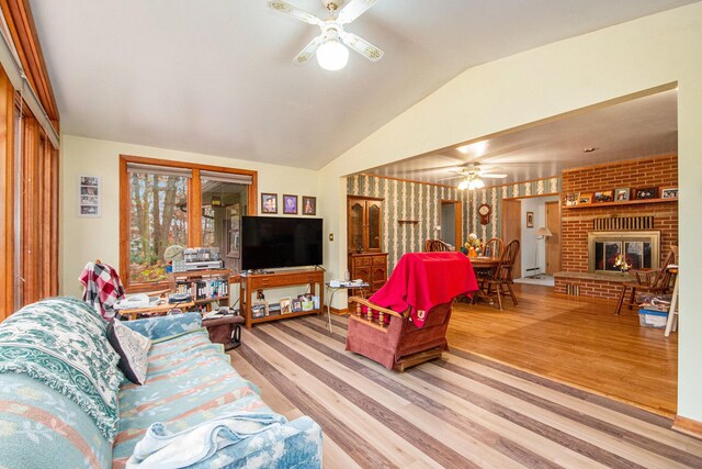 288 E 88th St, Newaygo, MI 49337 - living area featuring ceiling fan, lofted ceiling, wood finished floors, a fireplace, and a baseboard heating unit