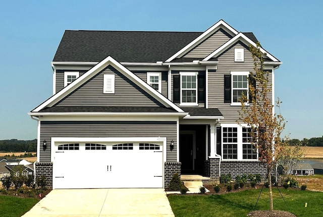 craftsman-style house featuring a garage and a front lawn