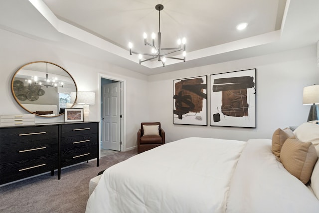 carpeted bedroom with an inviting chandelier and a raised ceiling