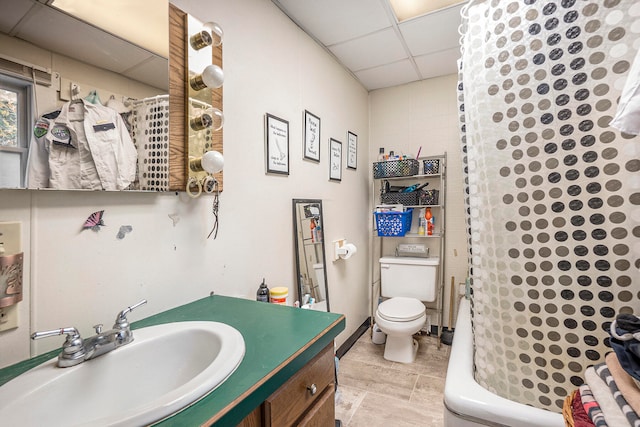 full bathroom with a paneled ceiling, vanity, radiator, toilet, and shower / tub combo with curtain