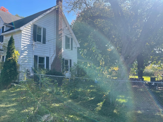 view of home's exterior with a lawn