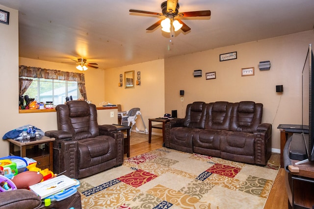 living room with wood-type flooring and ceiling fan