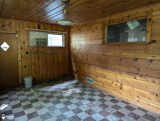 entrance foyer with cooling unit, wood ceiling, and wooden walls