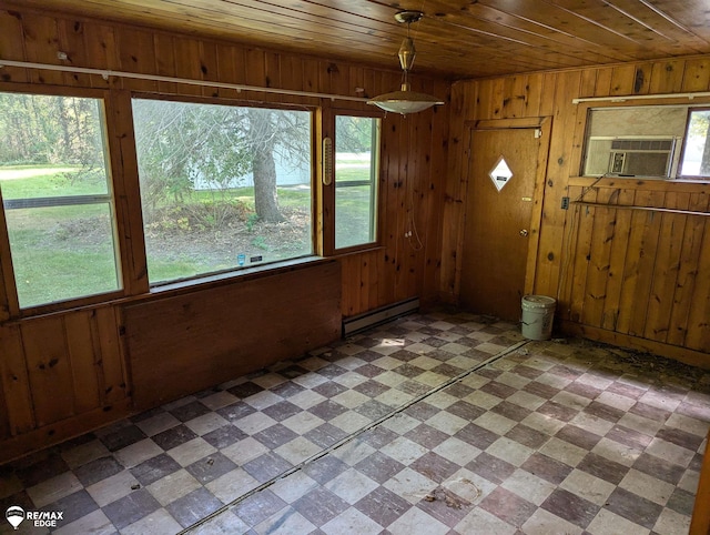 interior space with a healthy amount of sunlight, wooden ceiling, baseboard heating, and cooling unit