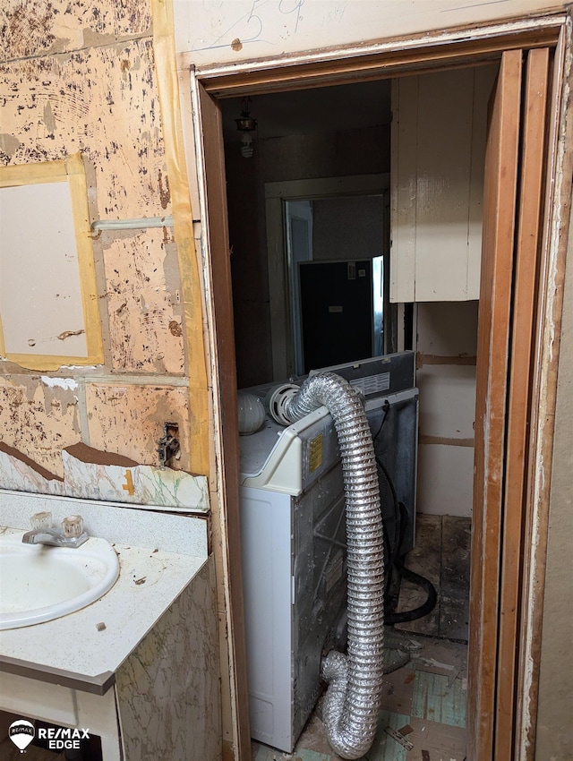 utility room featuring washer / dryer and sink