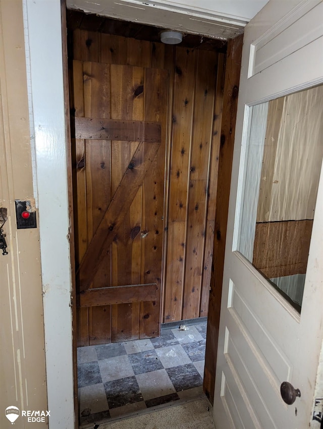 doorway with wood walls