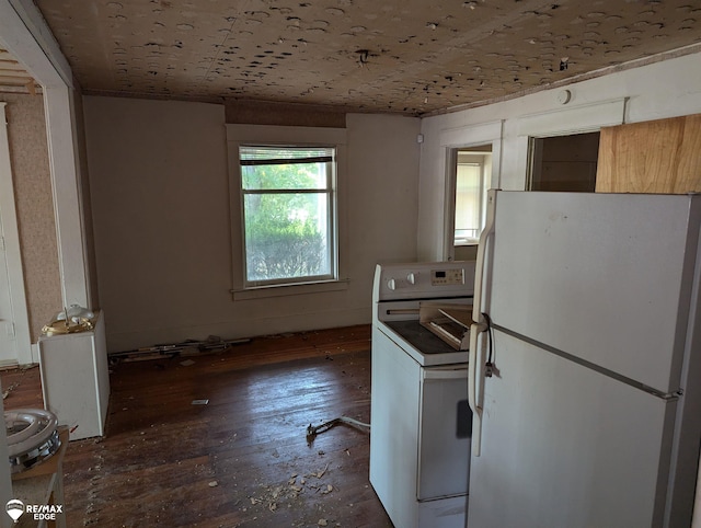 kitchen with dark hardwood / wood-style flooring, white fridge, and washer / clothes dryer