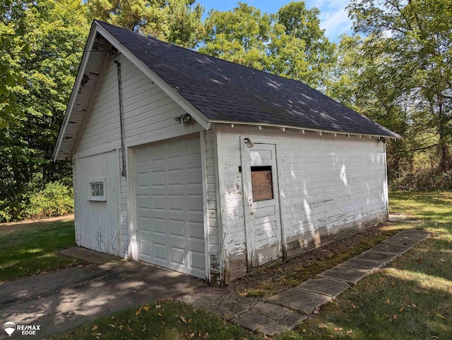 garage featuring a lawn