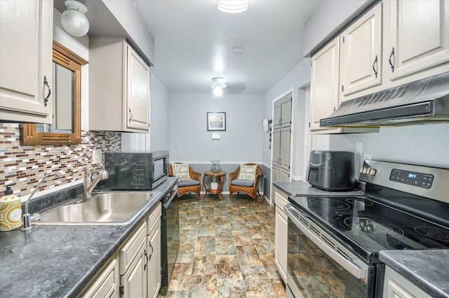 kitchen featuring backsplash, white cabinetry, sink, and appliances with stainless steel finishes