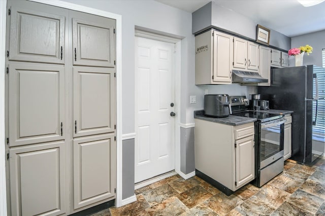 kitchen featuring black refrigerator and stainless steel range with electric cooktop