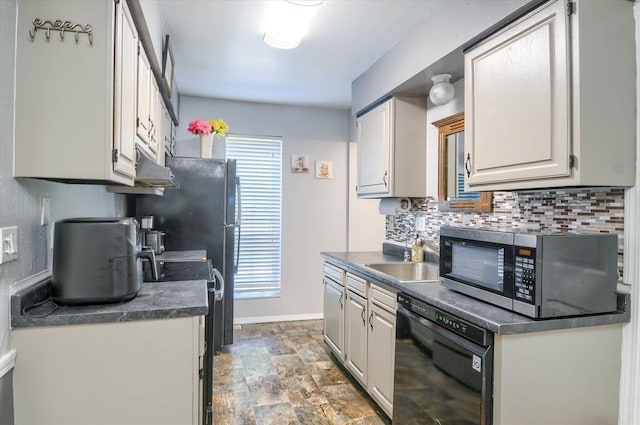 kitchen with range, black dishwasher, backsplash, and sink