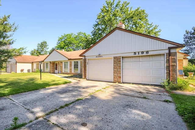 view of front of home with a garage and a front lawn