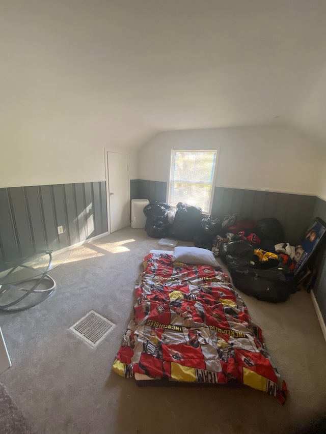 interior space featuring lofted ceiling and carpet floors