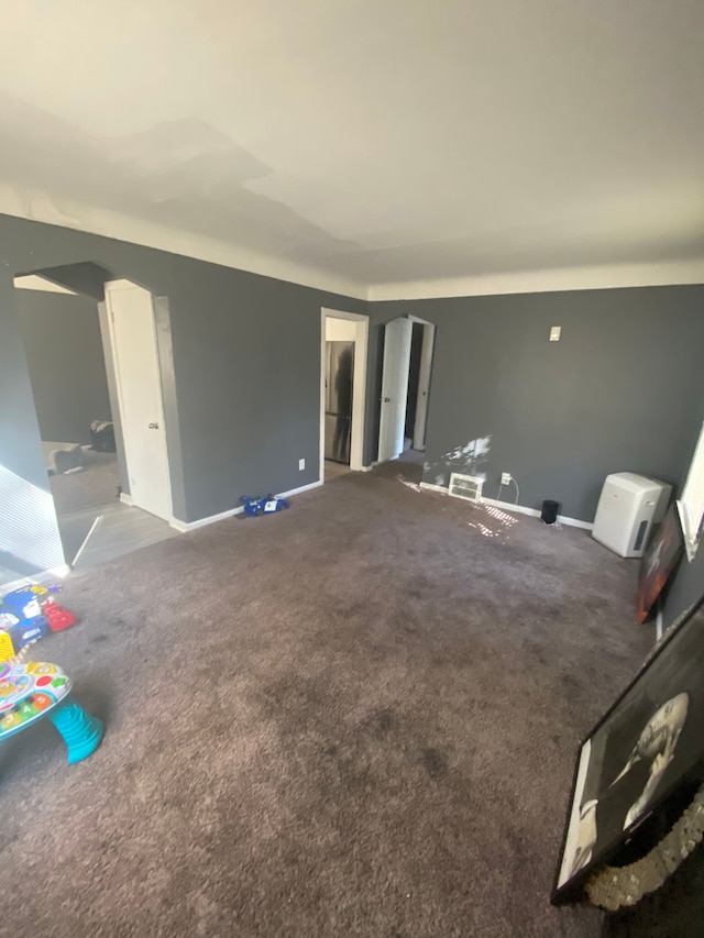 unfurnished living room featuring carpet floors