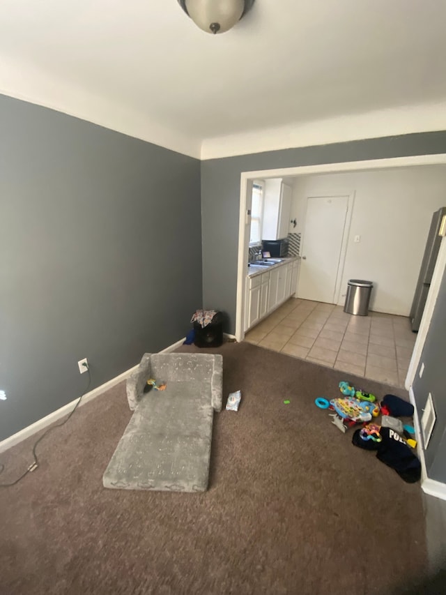 interior space with sink and light colored carpet