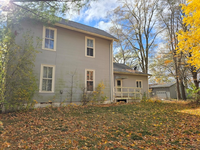 view of home's exterior featuring an outbuilding, a garage, and a lawn