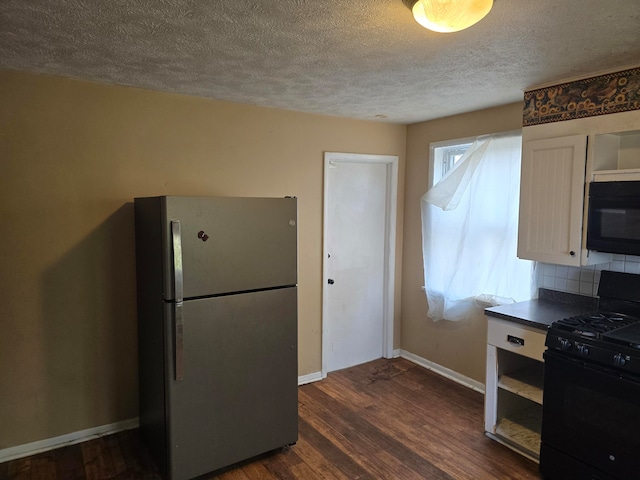 kitchen featuring dark wood-type flooring, black appliances, white cabinets, a textured ceiling, and tasteful backsplash