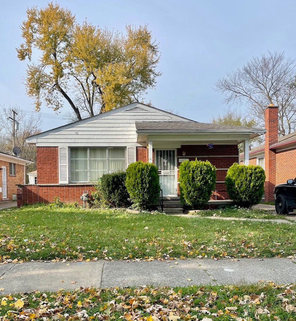 ranch-style house with a front lawn