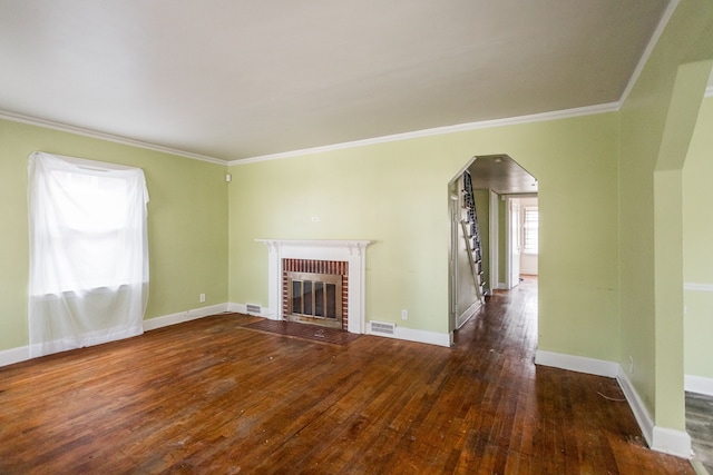 unfurnished living room with dark hardwood / wood-style floors, a brick fireplace, and crown molding