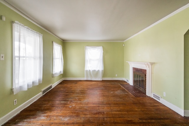 unfurnished living room with crown molding, dark wood-type flooring, and a brick fireplace