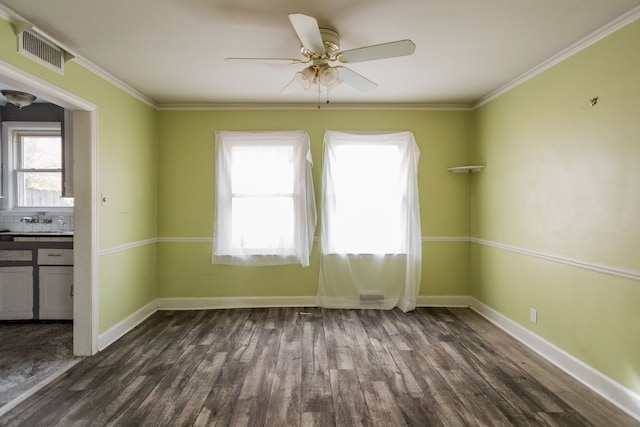 spare room with dark hardwood / wood-style floors and a wealth of natural light