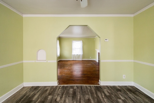 unfurnished room featuring dark hardwood / wood-style flooring, ceiling fan, and ornamental molding