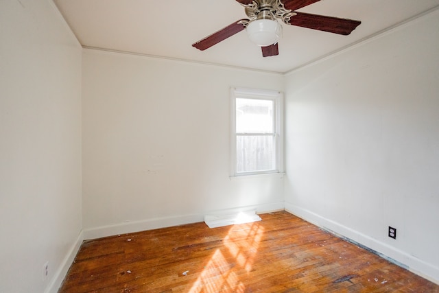 spare room with ceiling fan, crown molding, and hardwood / wood-style flooring