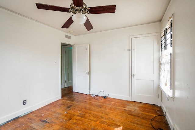 unfurnished bedroom with wood-type flooring, ceiling fan, and ornamental molding