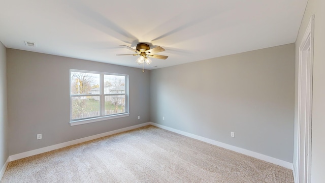 carpeted empty room featuring ceiling fan