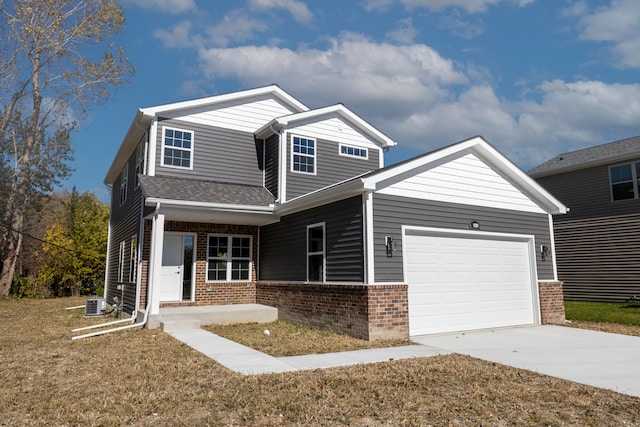 craftsman house with cooling unit, a garage, and a front yard