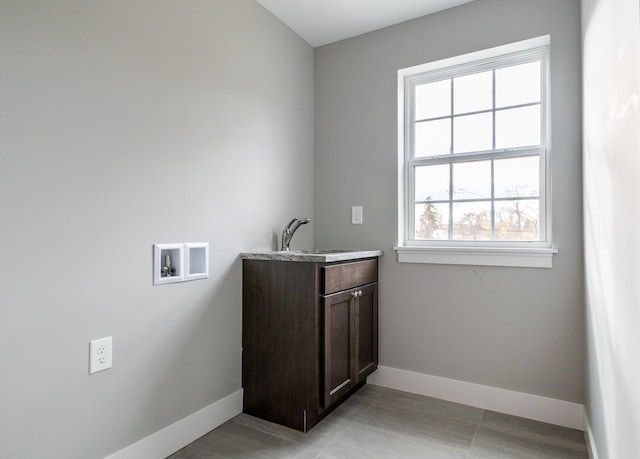 washroom featuring cabinets, washer hookup, and sink