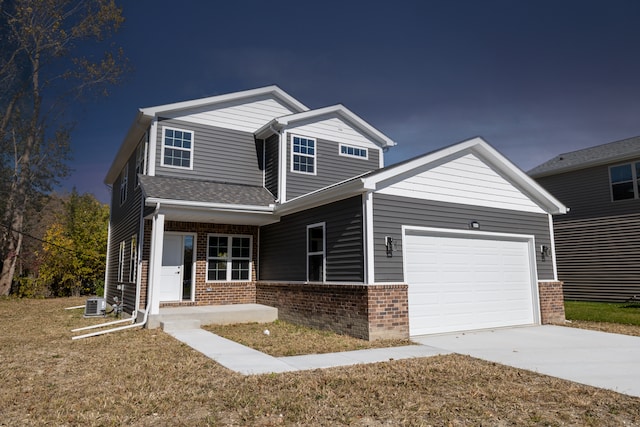 craftsman-style house with a front yard, a garage, central AC unit, and covered porch