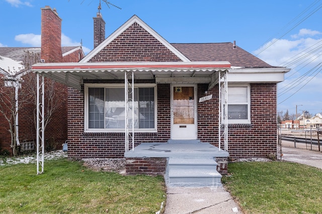 bungalow-style home featuring a front lawn