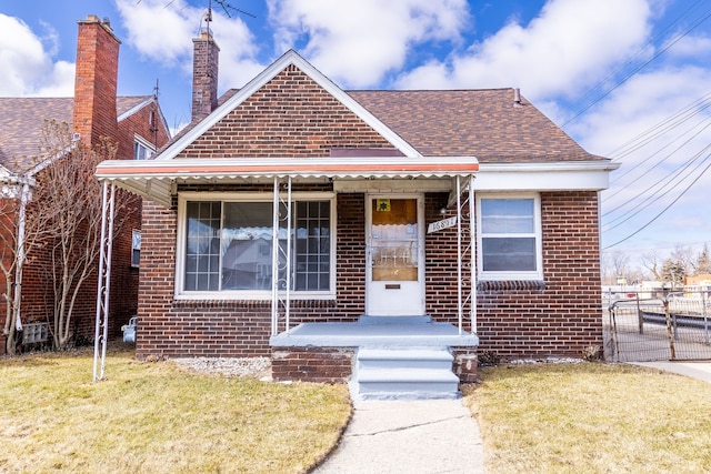 bungalow-style home featuring brick siding, a shingled roof, fence, a porch, and a front yard