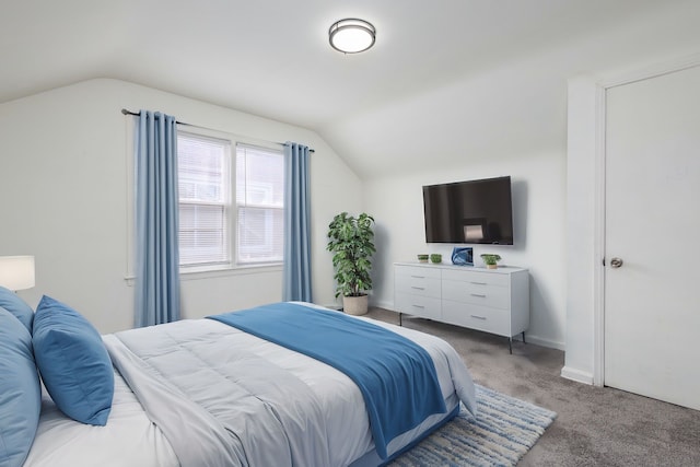 bedroom with lofted ceiling, light carpet, and baseboards