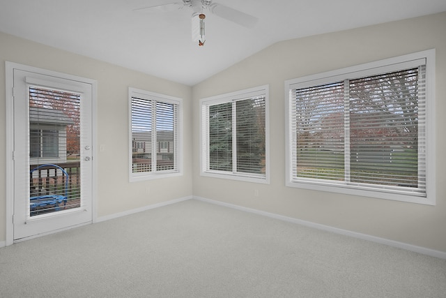 carpeted spare room with vaulted ceiling and ceiling fan