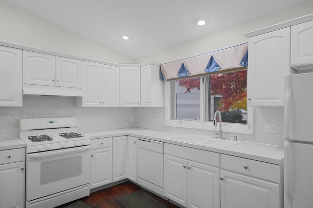 kitchen with white appliances, white cabinetry, and sink