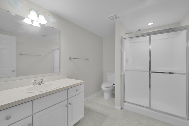 bathroom with an enclosed shower, vanity, and toilet