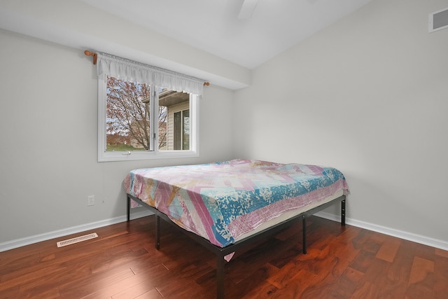 bedroom with dark hardwood / wood-style floors and ceiling fan