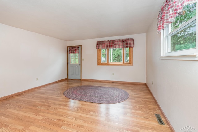 empty room with light hardwood / wood-style floors