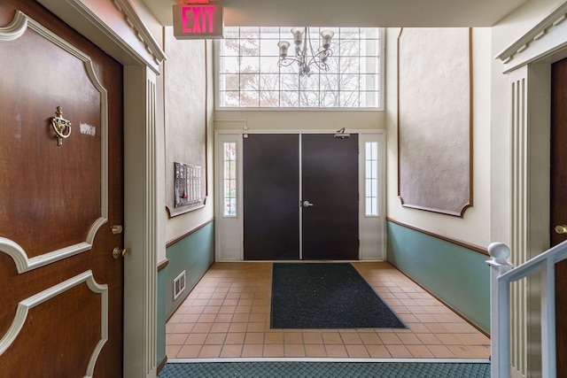 foyer entrance featuring tile patterned flooring and a wealth of natural light