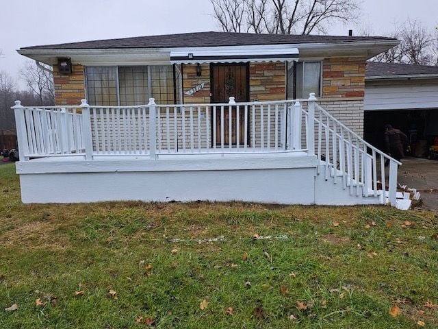 back of house with a yard and an attached garage