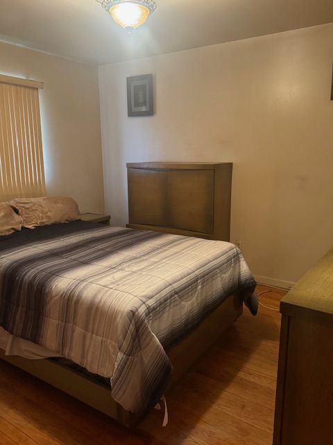 bedroom featuring light wood-type flooring and baseboards